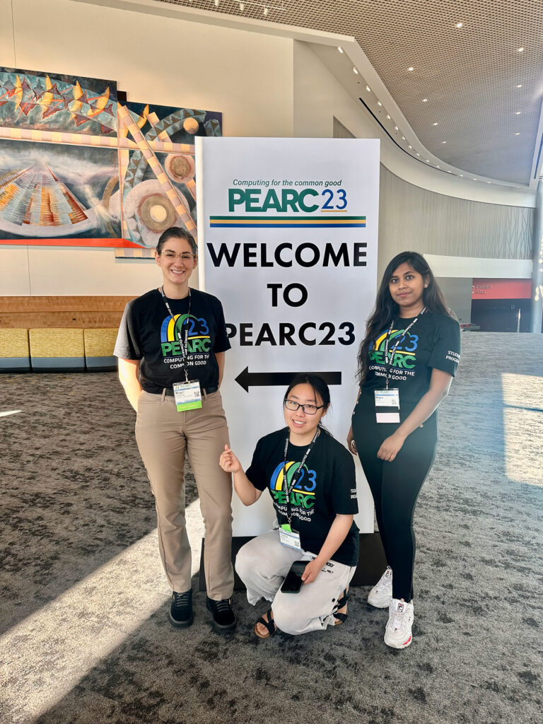 STEP Interns stand in front of a sign for PEARC23