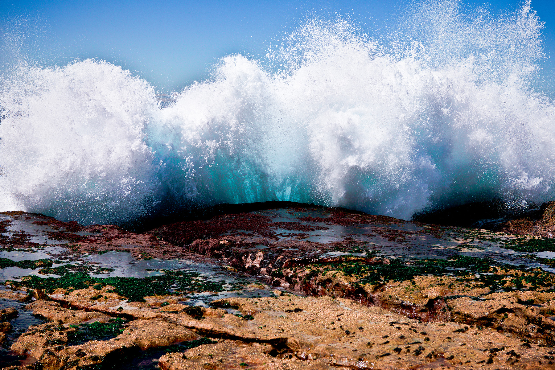 Ocean waves crashing into a rocky shore